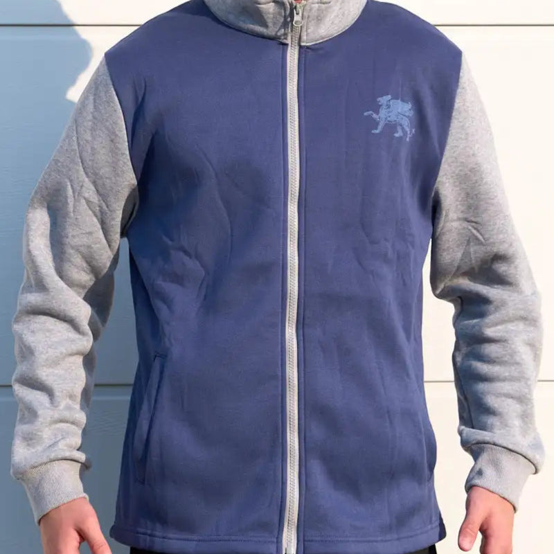 Person wearing a blue and gray jacket with a logo on a white background