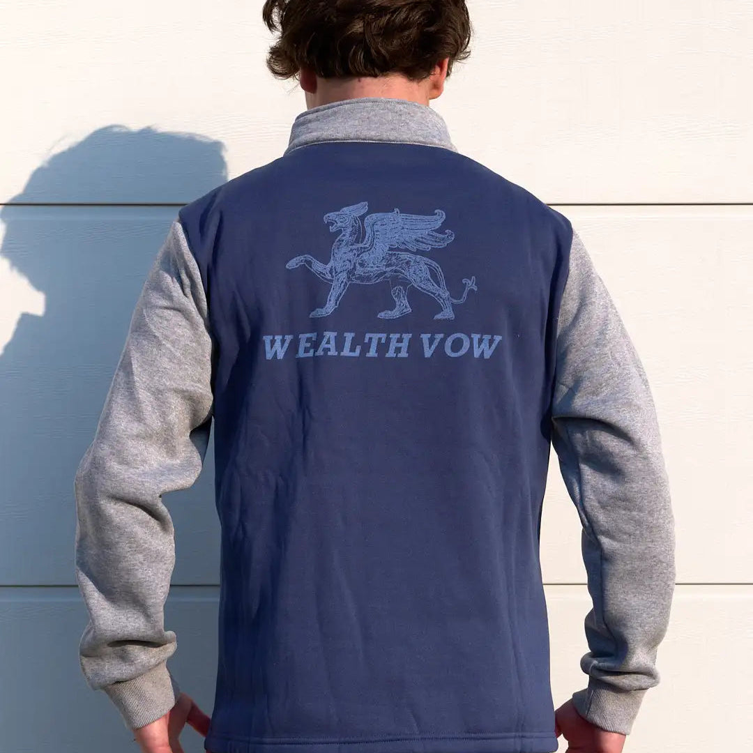 Person wearing a blue and gray jacket with 'WEALTH VOW' branding on the back.